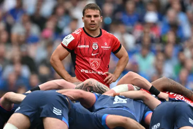 Antoine Dupont stands back from a scrum