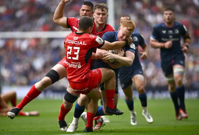 Ciarán Frawley is tackled by Thomas Ramos