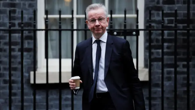 Michael Gove walks in front of Downing Street