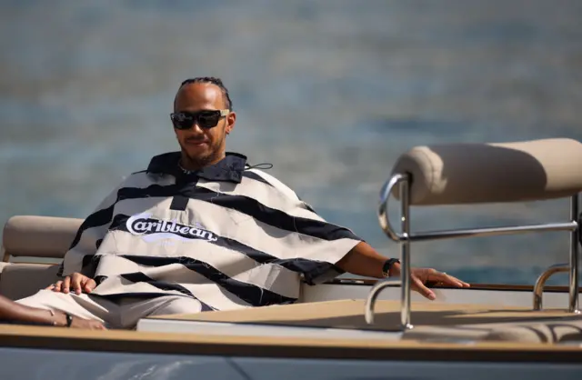 Lewis Hamilton wears sunglasses on a Monaco boat