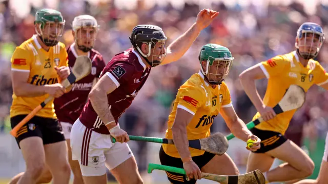 Galway's Padraic Mannion closes in on Antrim forward Nigel Elliott