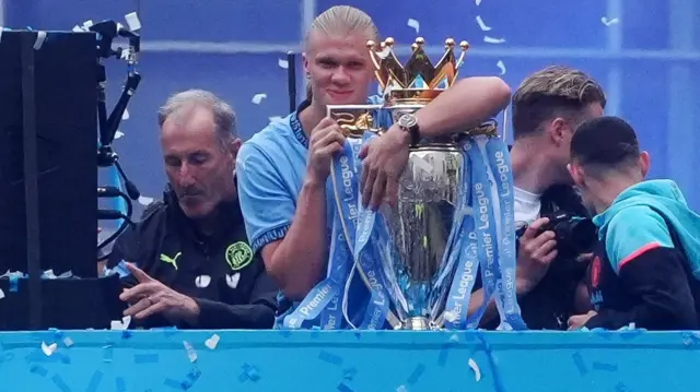 Erling Haaland hugs the Premier League trophy