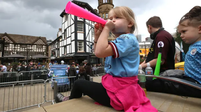 Young Manchester City fan celebrates their Premier League win