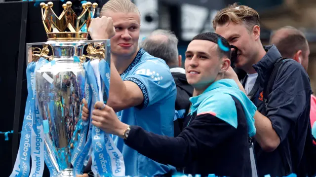 Manchester City's Erling Haaland (left) and Phil Foden with the Premier League trophy