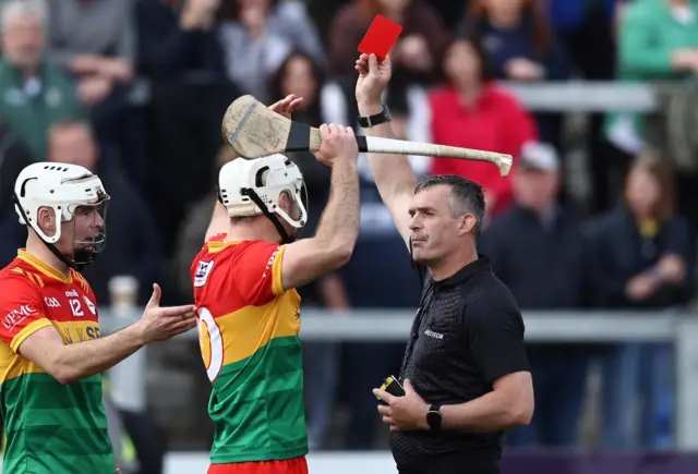 Chris Nolan is shown a red card by referee James Owens