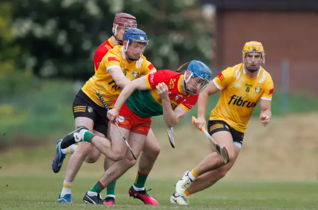 Ciaran Whelan is challenged by Keelan Molloy and Michael Bradley