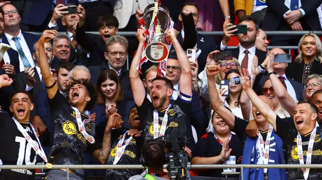 Jack Stephens lifts the trophy