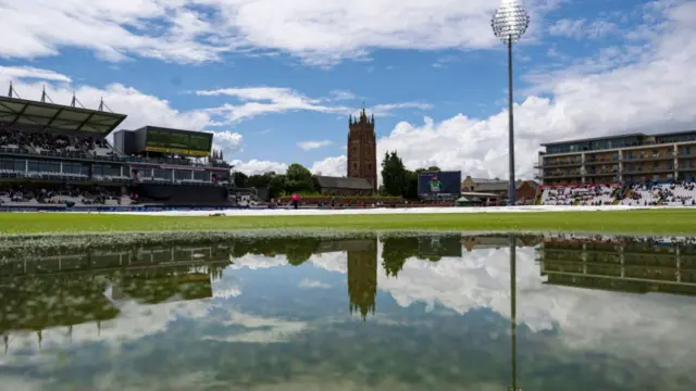 Sunshine over the County Ground at Taunton with a large puddle on the outfield