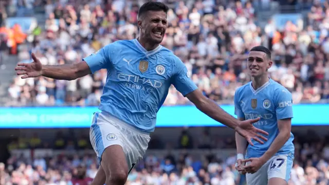 Manchester City's Rodri celebrates scoring their side's third goal of the game during the Premier League match at the Etihad Stadium