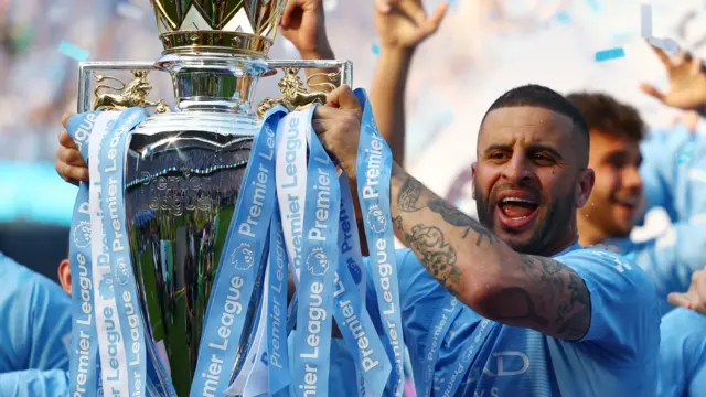 Manchester City's Kyle Walker celebrates with the trophy after winning the Premier League