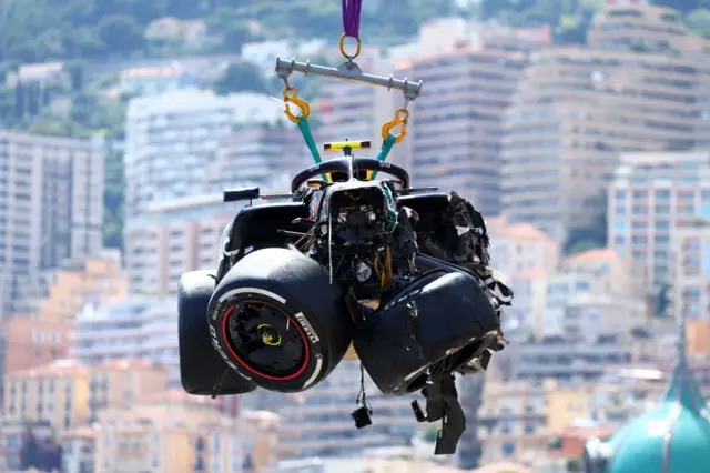 Sergio Perez's car being moved off the track