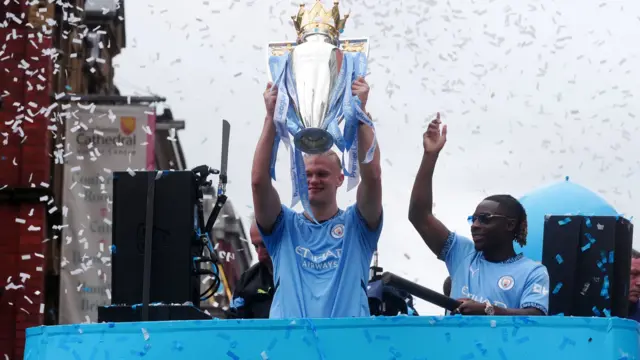 Manchester City's Erling Haaland lifts the Premier League trophy during a parade in Manchester