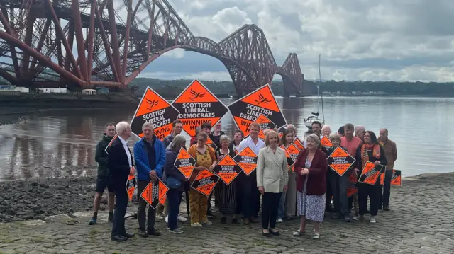 Lib Dem activists in front of Forth bridge