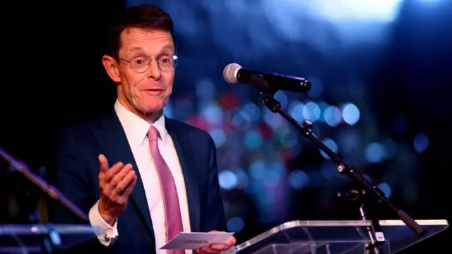 Andy Street speaks at a lectern