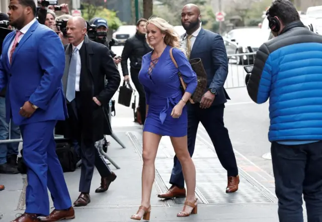 Adult film actress Stormy Daniels walks on a New York sidewalk in 2018