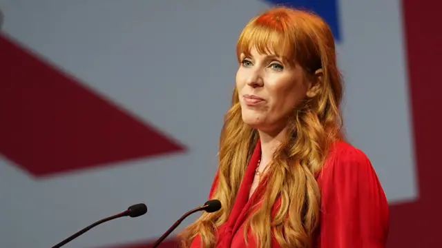 Angela Rayner at a lectern in front of a union flag