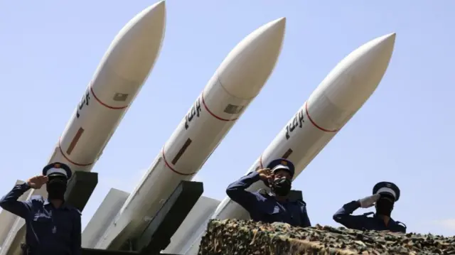 Yemeni general saluting in front of missiles