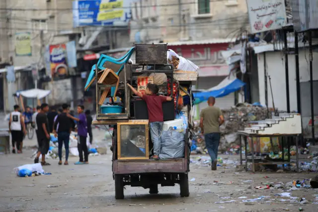 Palestinians flee the area of Tal al-Sultan in Rafah with their belongings