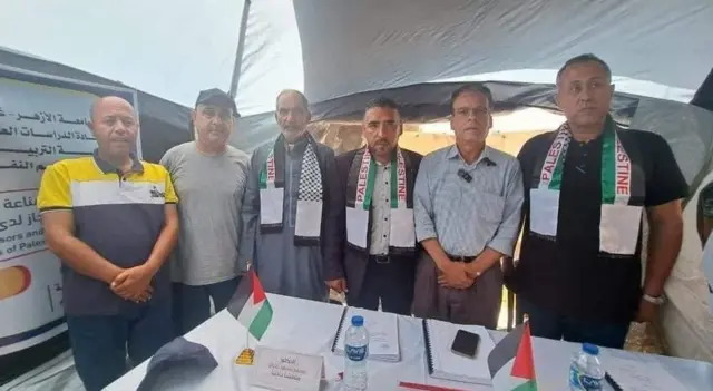 Dr Imad al-Kahlout (right) and his colleagues in a tented displacement camp in Rafah