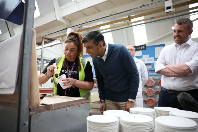 Rishi Sunak watches a worker at a pottery business