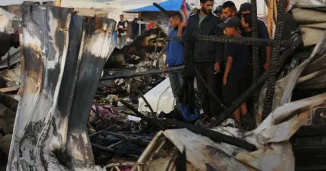 People look at destroyed buildings in Rafah, southern Gaza and people in Rafah, Gaza