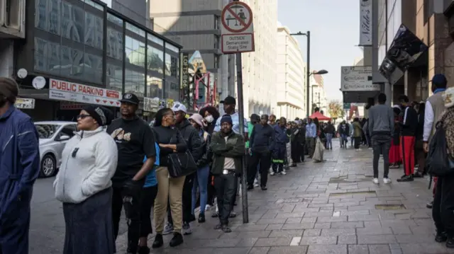 Voters wait in line outside the Central Methodist Church polling station in Johannesburg's Central Business District, on May 29, 2024