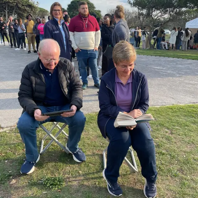 People reading at a polling station in Gqeberha, South Africa