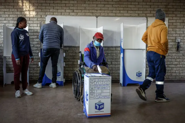 Jeffrey Benzane, 75, casts his ballot at Hitekani Primary School polling station in Soweto on May 29, 2024, during South Africa's general election.