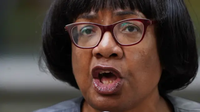 Veteran MP Diane Abbott speaks into a microphone