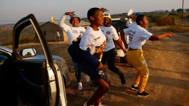 Supporters of the Inkatha Freedom Party (IFP) dance near a polling station during the South African elections in Nkandla, South Africa, May 29, 2024