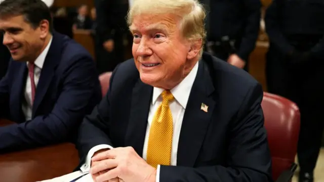 Donald Trump sits at the defence table in a New York courtroom