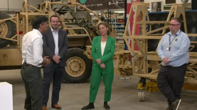 Rishi Sunak speaks with a voter at a warehouse in Devon