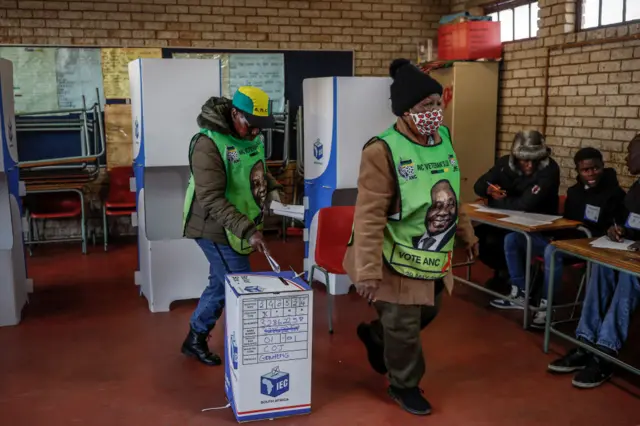 Voters wearing African National Congress (ANC) party merchandise cast their ballots at Hitekani Primary School polling station in Soweto on May 29, 2024, during South Africa's general election.