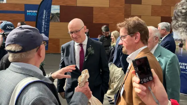 John Swinney speaks with voters