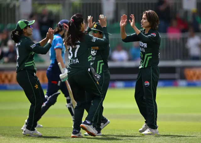 Pakistan celebrate the wicket of Maia Bouchier