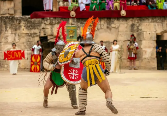 Mock gladiators in a real amphitheatre.