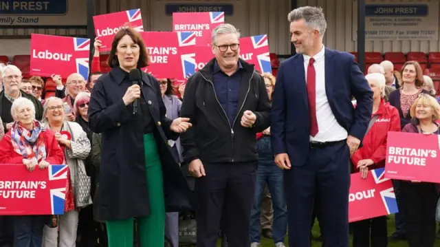 Rachel Reeves, Starmer and Skaith are flanked by supporters at Northallerton Town Football Club, North Yorkshire,