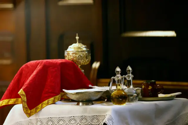 Catholic liturgical objects displayed over table at church.