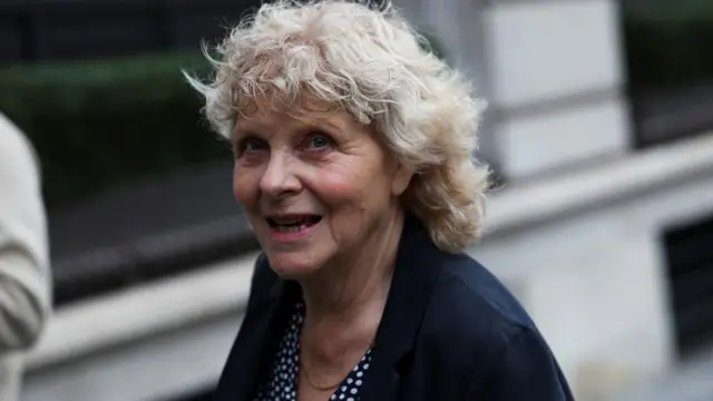 Former sub-postmistress Jo Hamilton walks into the Post Office inquiry dressed in a black jacket.