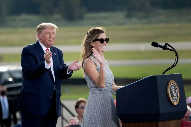 US President Donald Trump listens as aide Hope Hicks speaks during a Make America Great Again rally at Ocala International Airport in Ocala, Florida on October 16, 2020