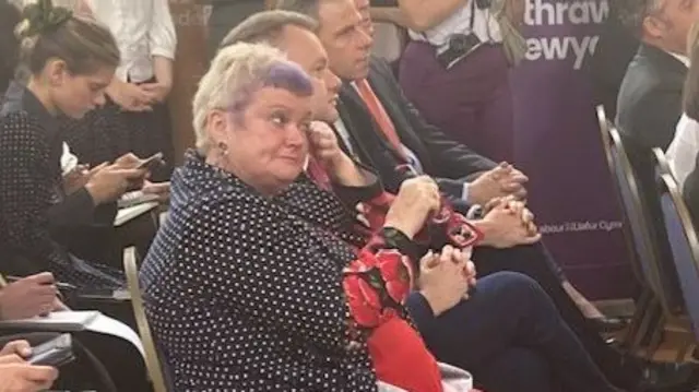 Candidate wipes her eye in the audience