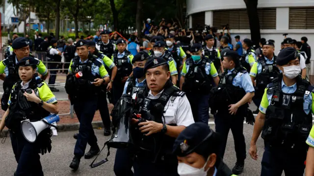 Police stand guard outside the West Kowloon Magistrates' Courts building during the verdict of the 47 pro-democracy activists charged under the national security law, in Hong Kong, China, May 30, 2024.