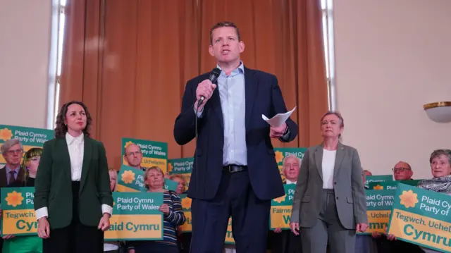 Plaid Cymru leader Rhun ap Iorwerth speaks into a microphone