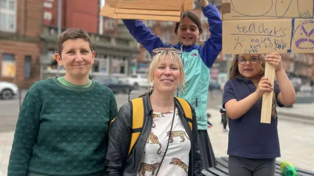 Fiona Sieber-Gordon and Cora Bissett with their children at a protest