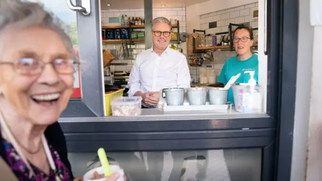 Starmer stands inside an ice cream parlour