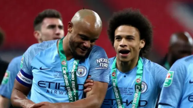 Vincent Kompany and Leroy Sane celebrate after Manchester City win the Carabao Cup final in 2019