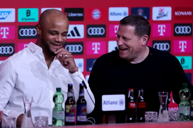 New Bayern Munich coach Vincent Kompany laughs with director of sports Max Eberl during Kompany's first news conference