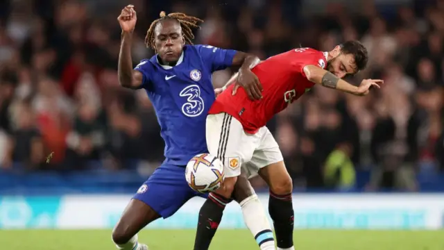 Manchester United's Bruno Fernandes battles for possession with Chelsea's Trevoh Chalobah
