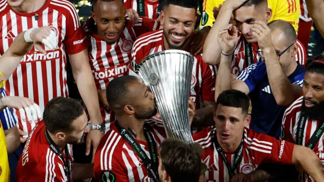 Ayoub El Kaabi kisses the Europa Conference League trophy