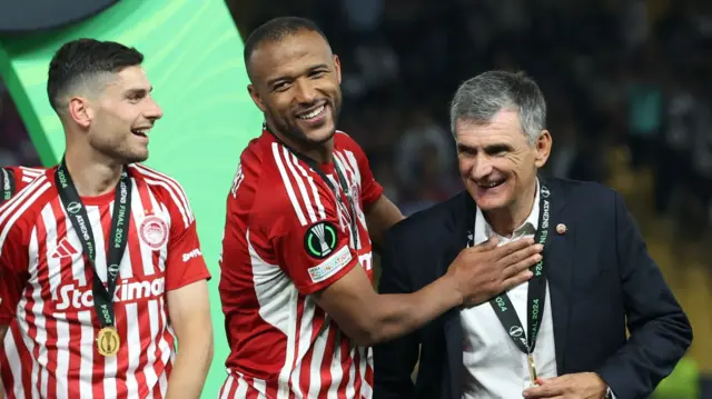 Ayoub El Kaabi celebrates with coach Jose Luis Mendilibar after Olympiakos win the Europa Conference League